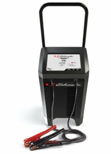 Schumacher Electric 200 amp 12 volt automatic battery charger and engine starter with wheels, long handle, and color-coded clamps.