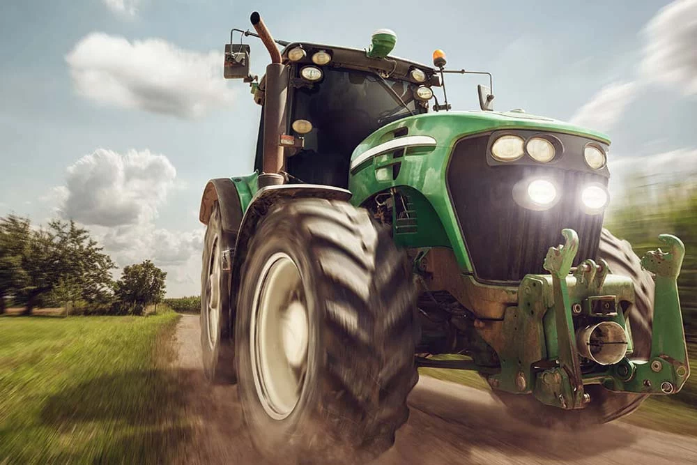 Tractor driving on a dirt road