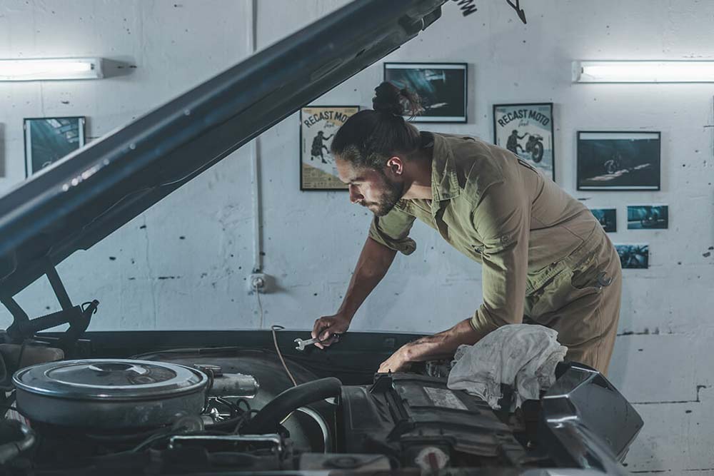 Man working on a car in a garage
