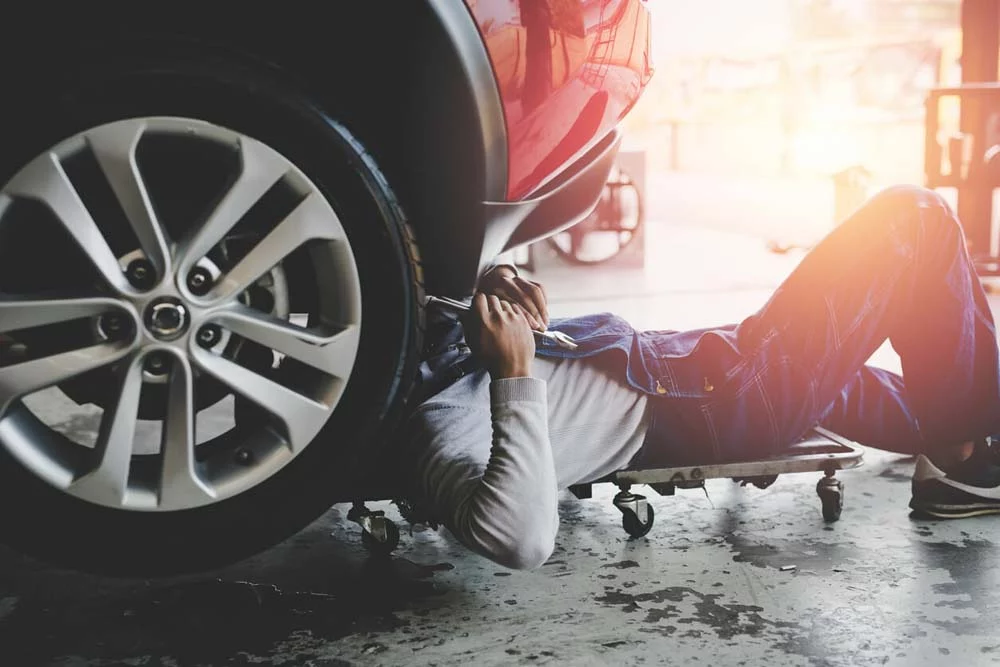 Man underneath a car fixing it