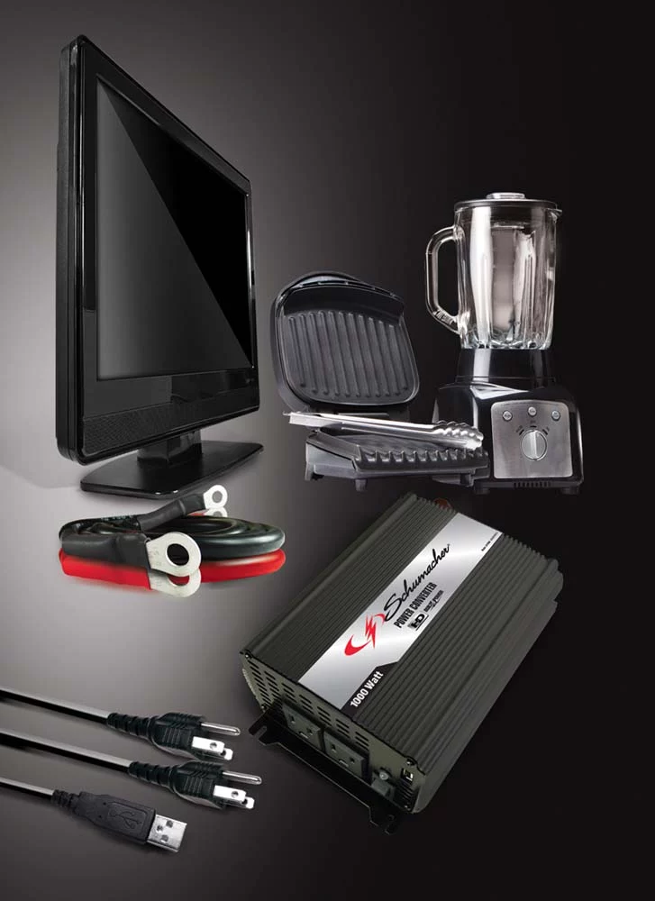 A Schumacher power converter sitting next to a blender, a television, and other items it can power